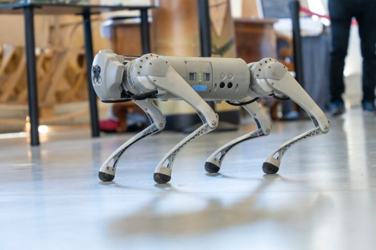 A quadruped robot walking indoors, showcasing advanced robotics technology in a modern setting.